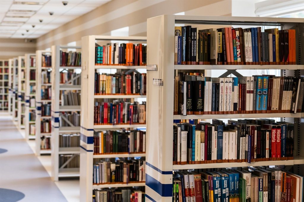 The shot shows a row of book shelves in a library.